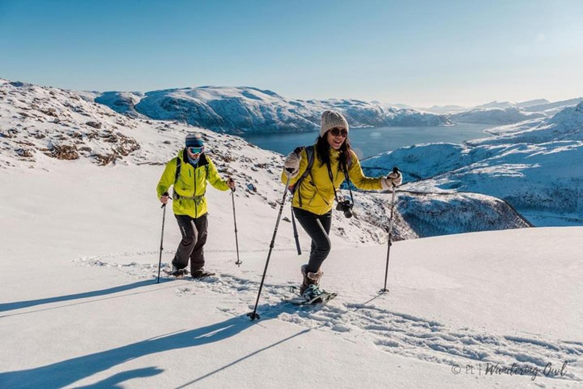 two people on skis on a snow covered mountain
