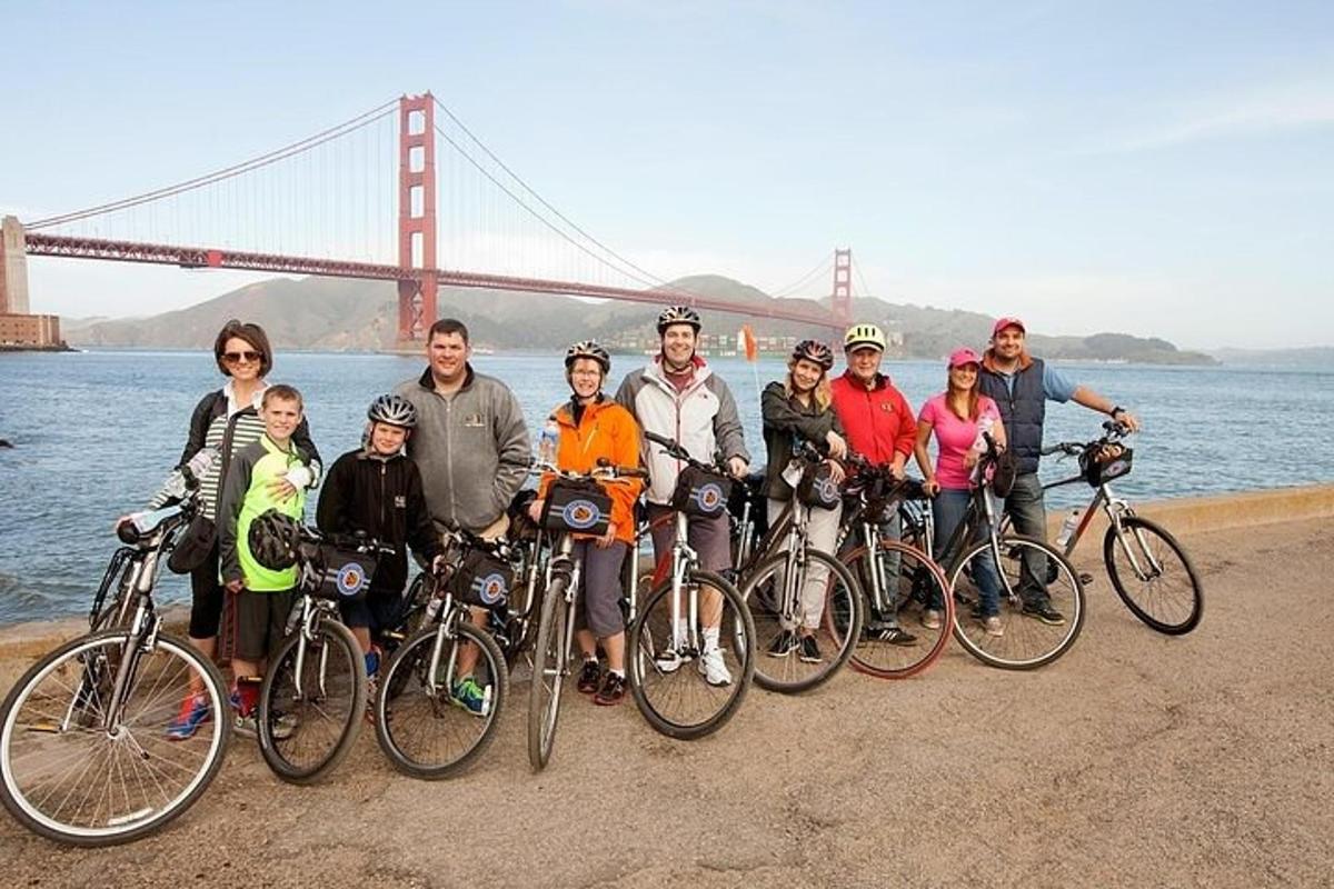 a group of people posing in front of the golden gate bridge