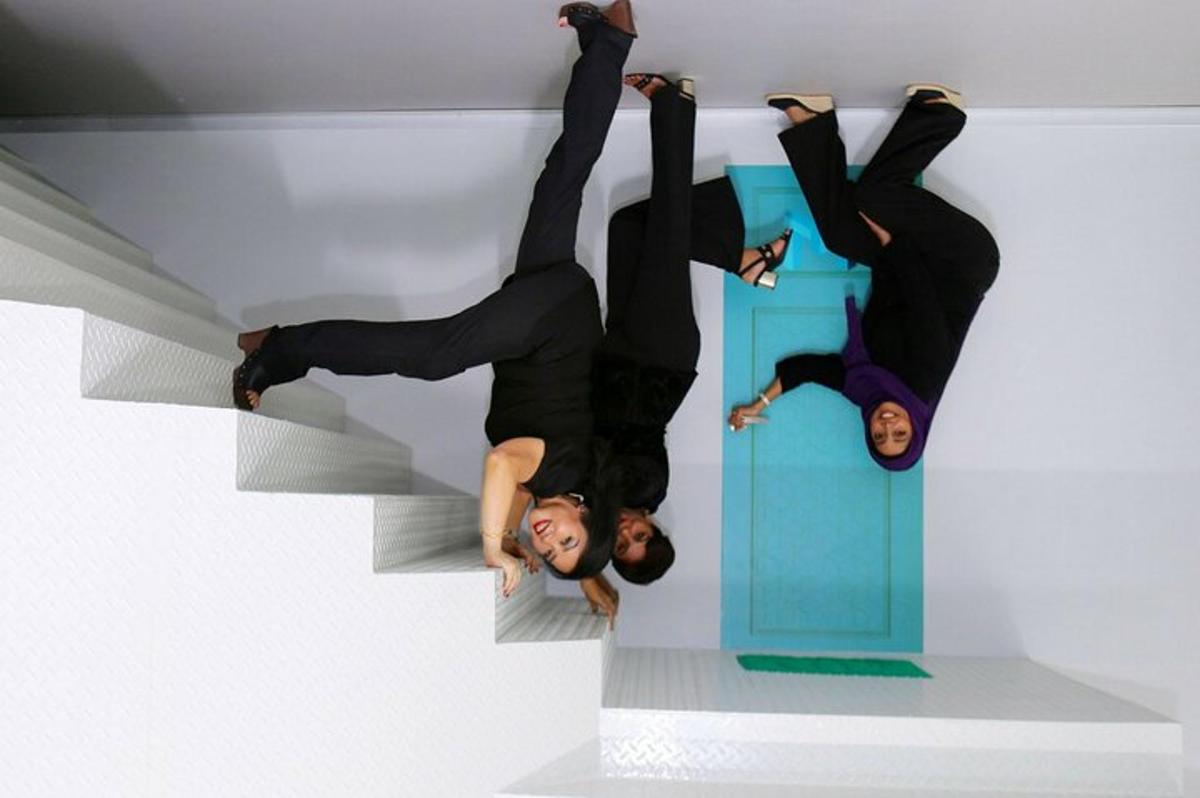 two people are standing on theirselves in a room
