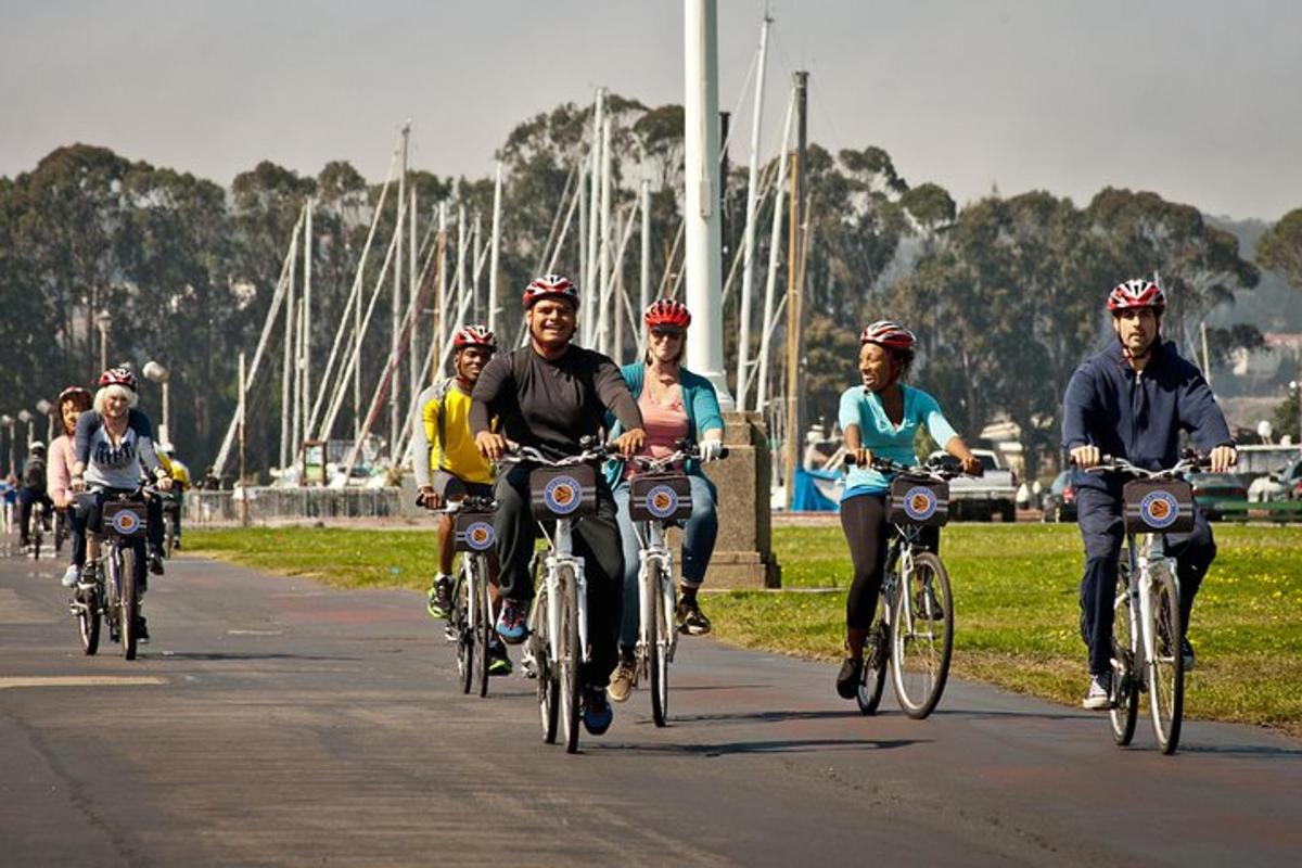 a group of people riding bikes down a road