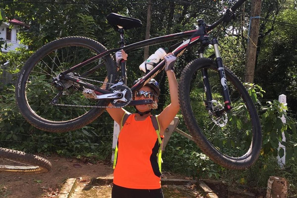 a woman is holding a bike in the air