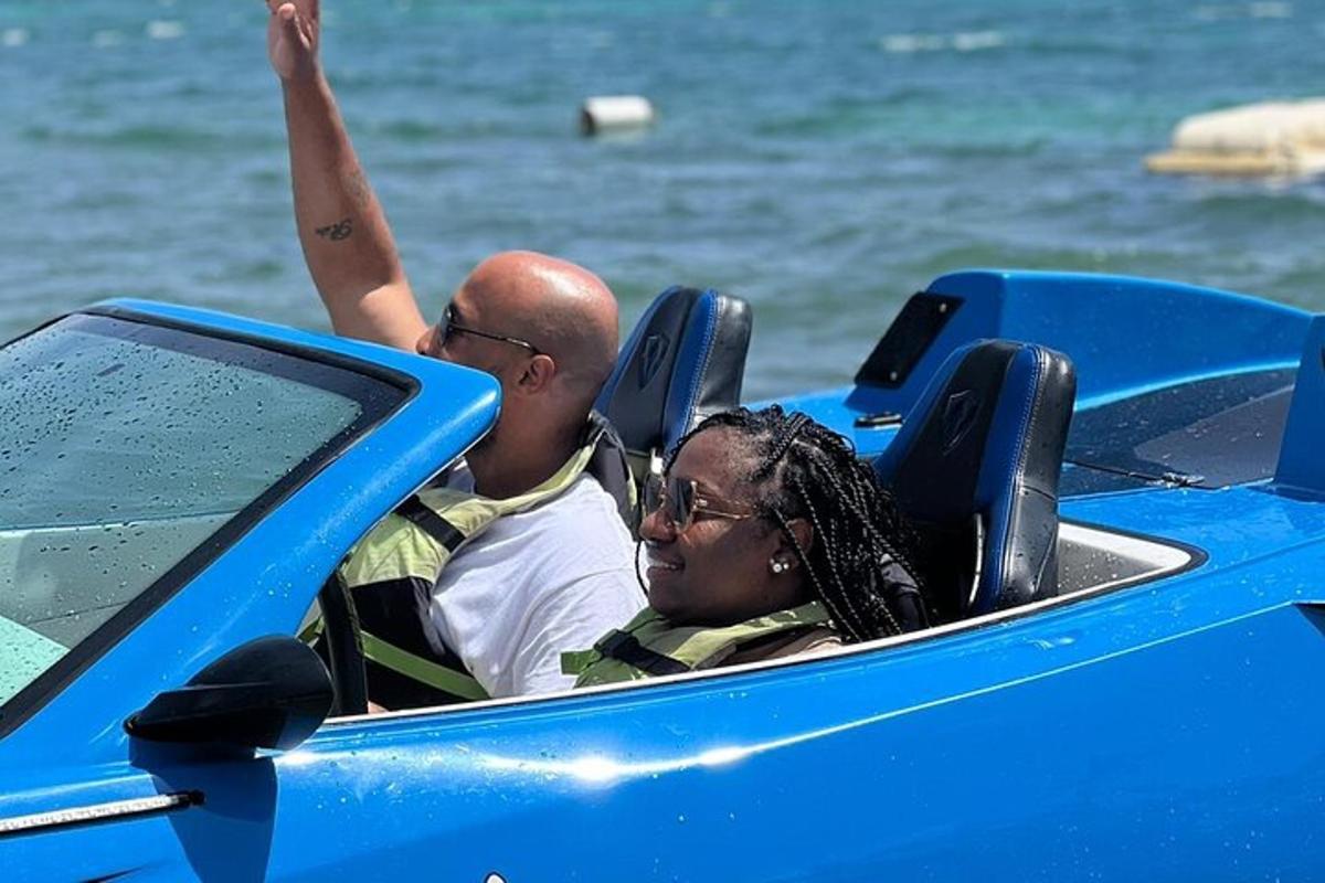 two people riding in a blue car in the water