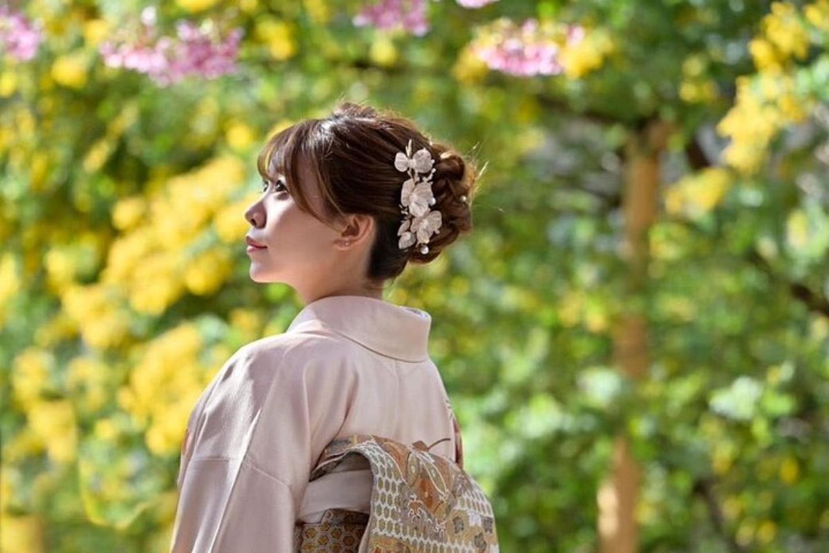 a woman is standing in front of some flowers