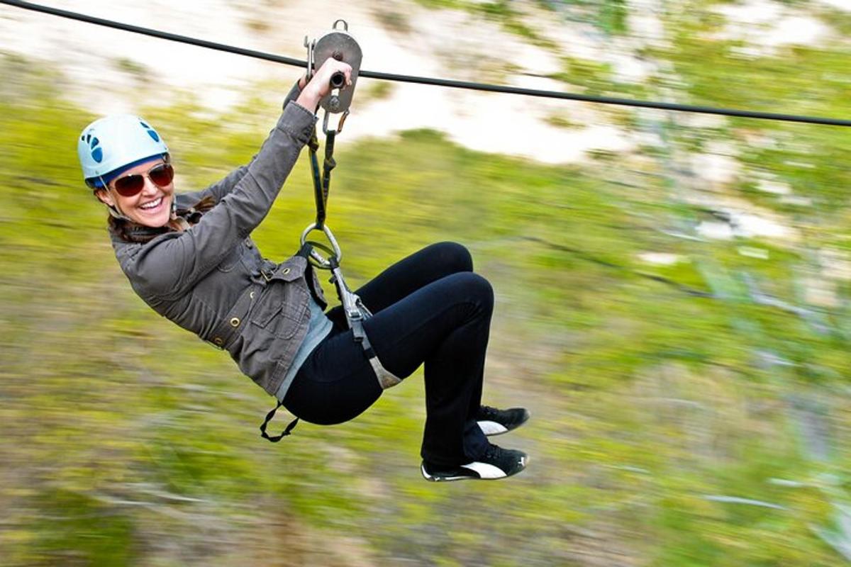 a woman is on a zip line