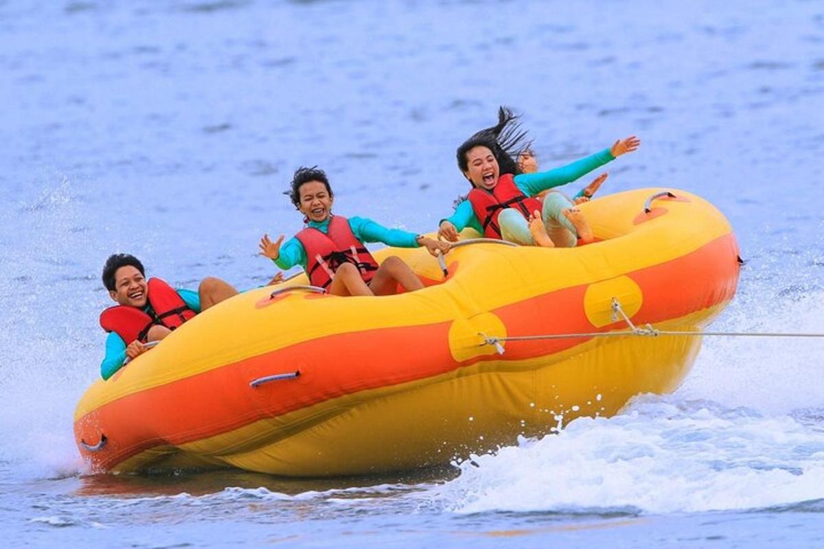three people on an orange raft in the water