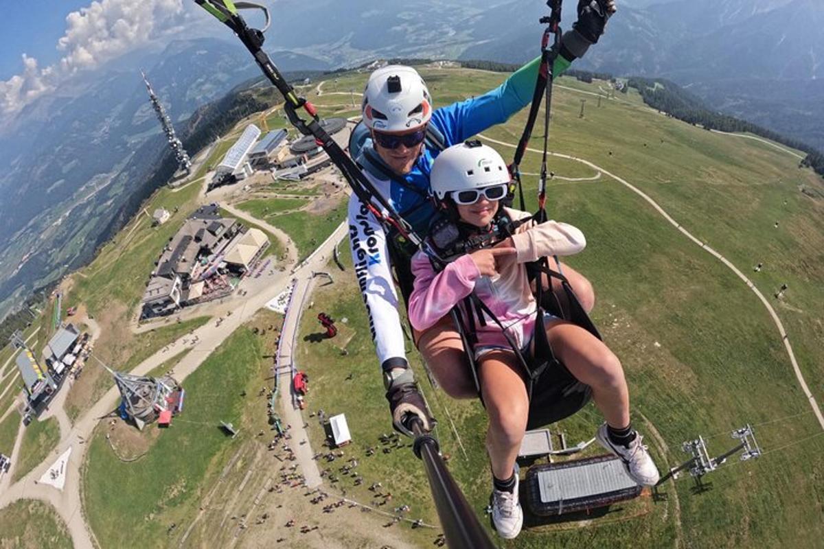 two people riding on a zip line in the air