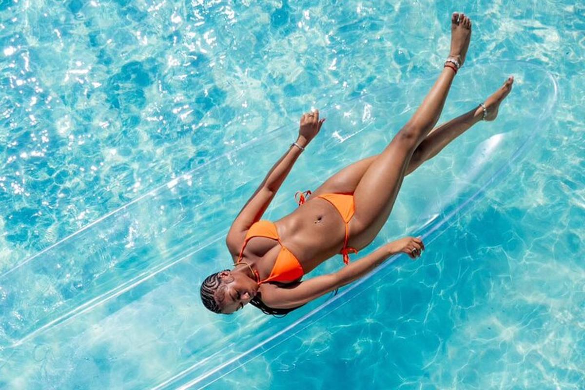 a woman in a bikini floating in a swimming pool