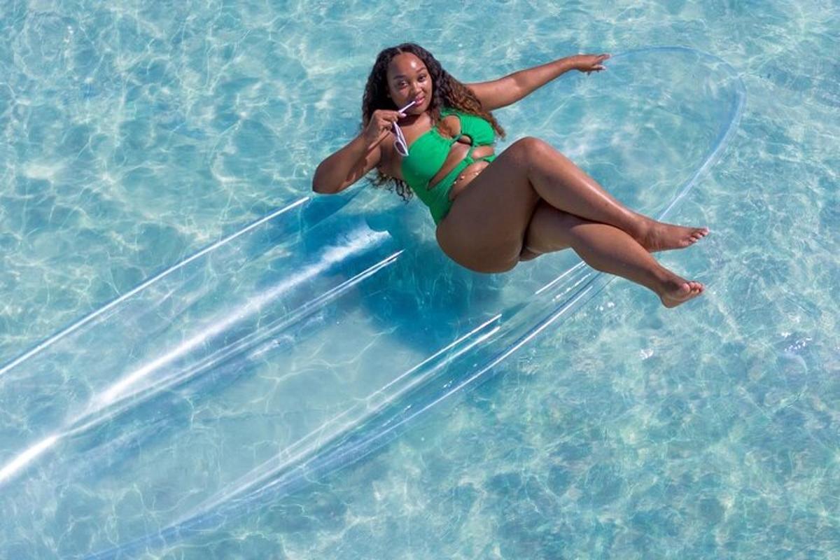 a woman in a green bikini is in the water