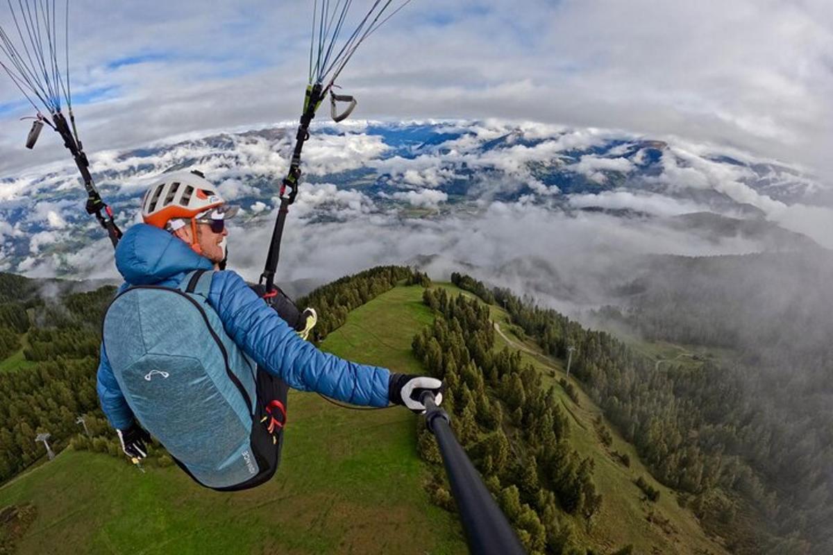 a man flying through the air on a parachute