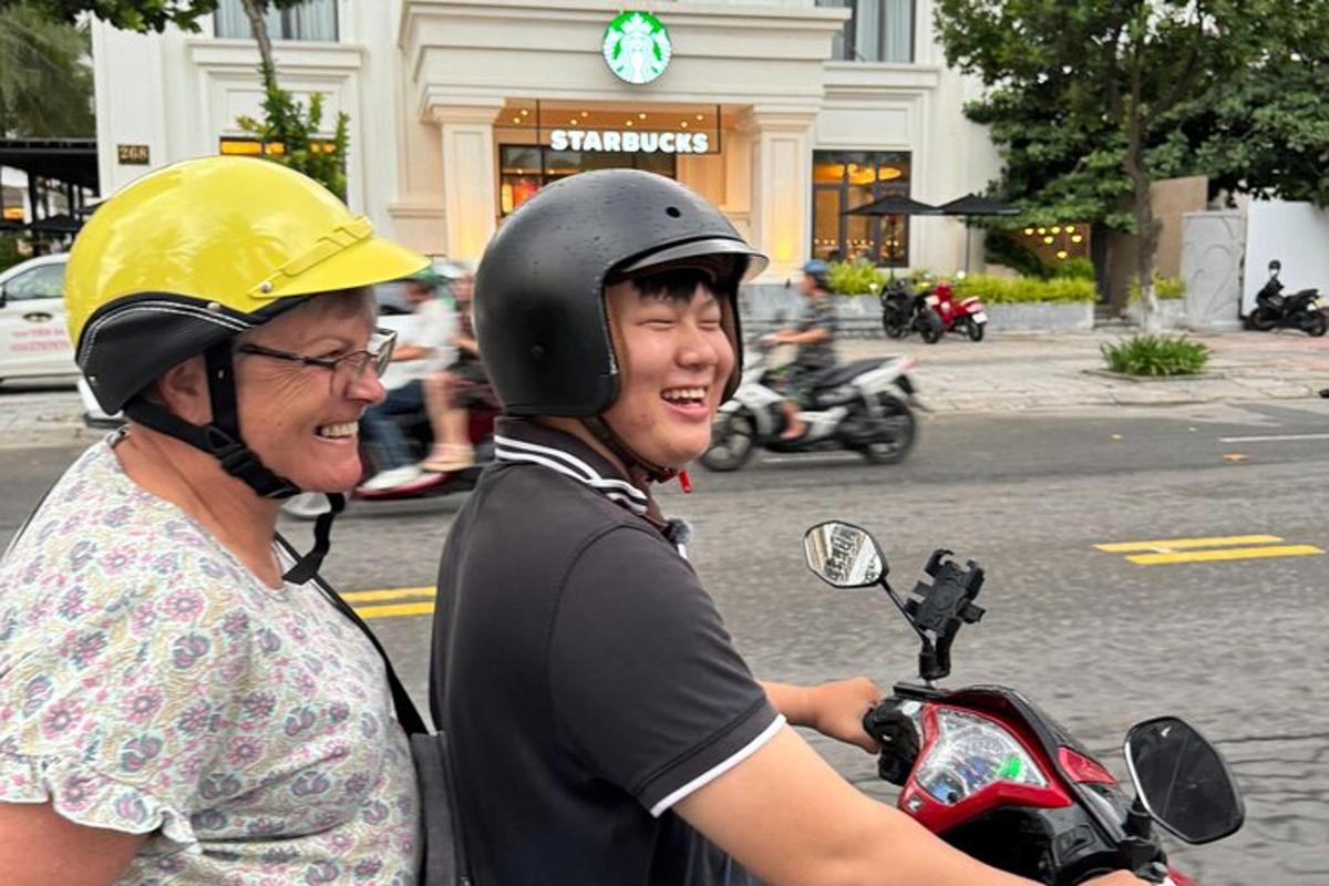 a woman and a man on a motorcycle