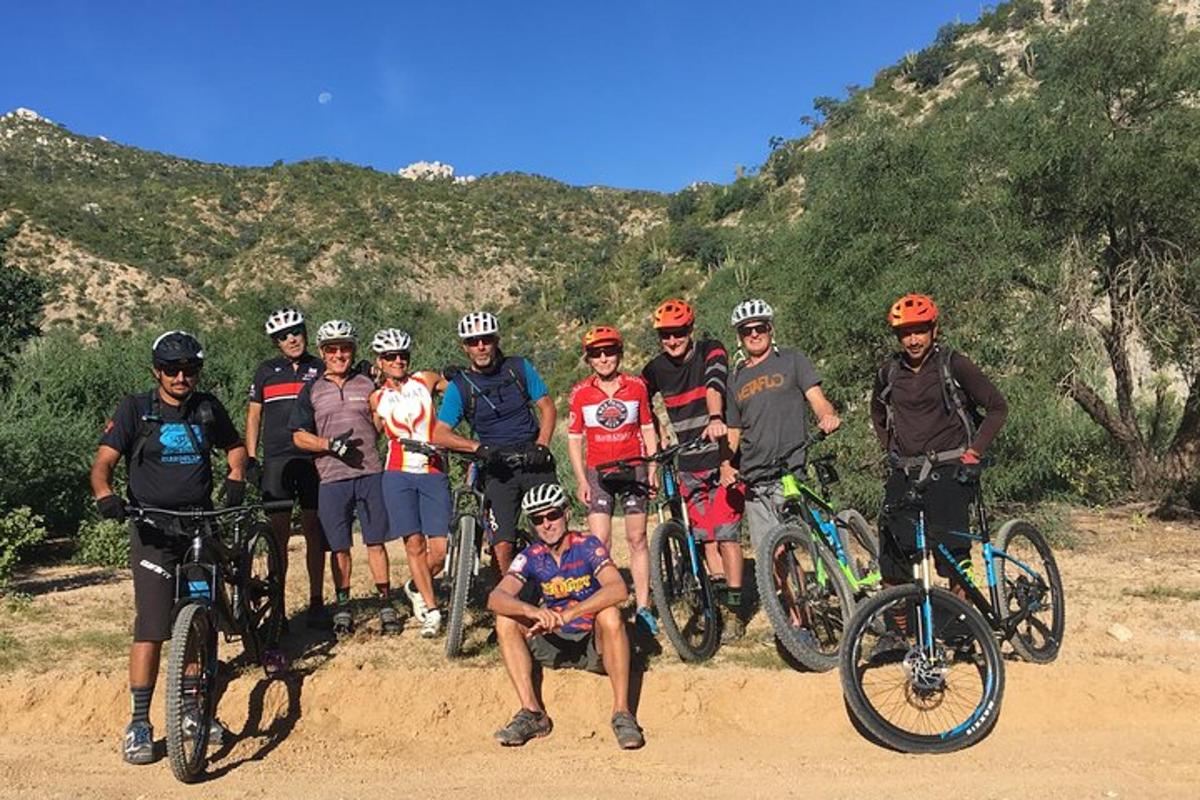 a group of people posing for a picture with their bikes