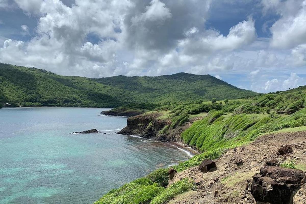 a large body of water with green hills