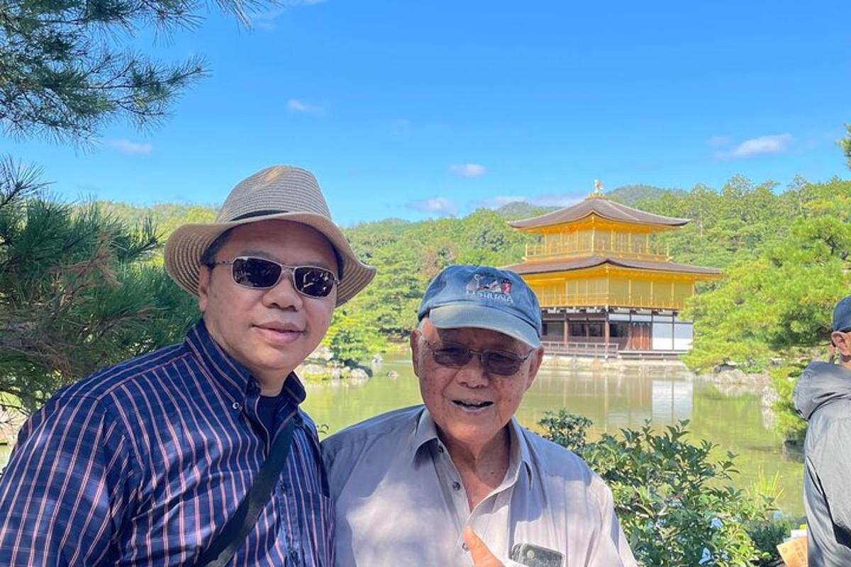 two older men are standing in front of a building