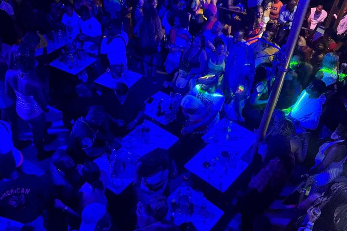 a crowd of people sitting at tables in a nightclub