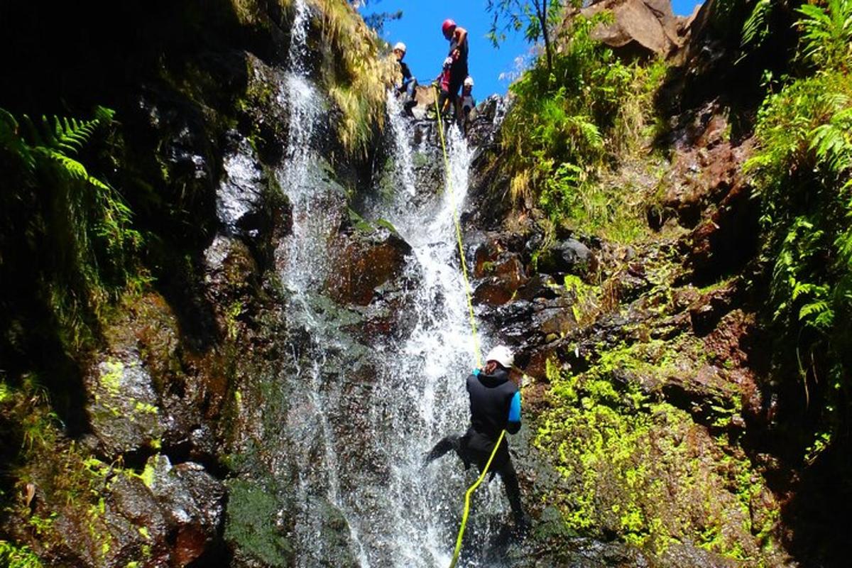 a man standing in front of a waterfall