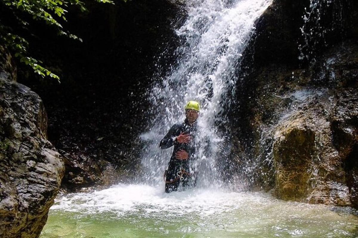 a man standing in front of a waterfall