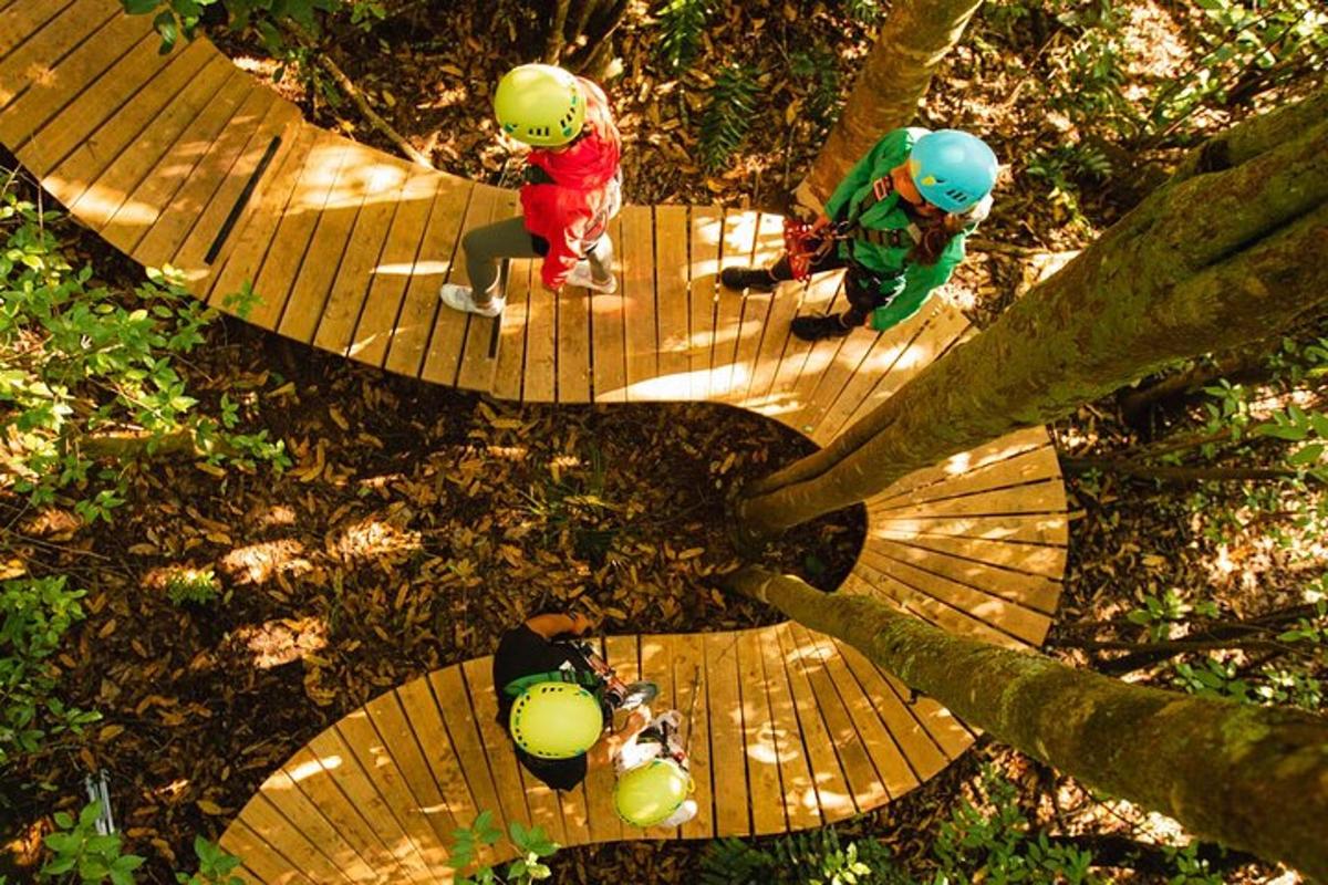two people with helmets sitting on a wooden walkway