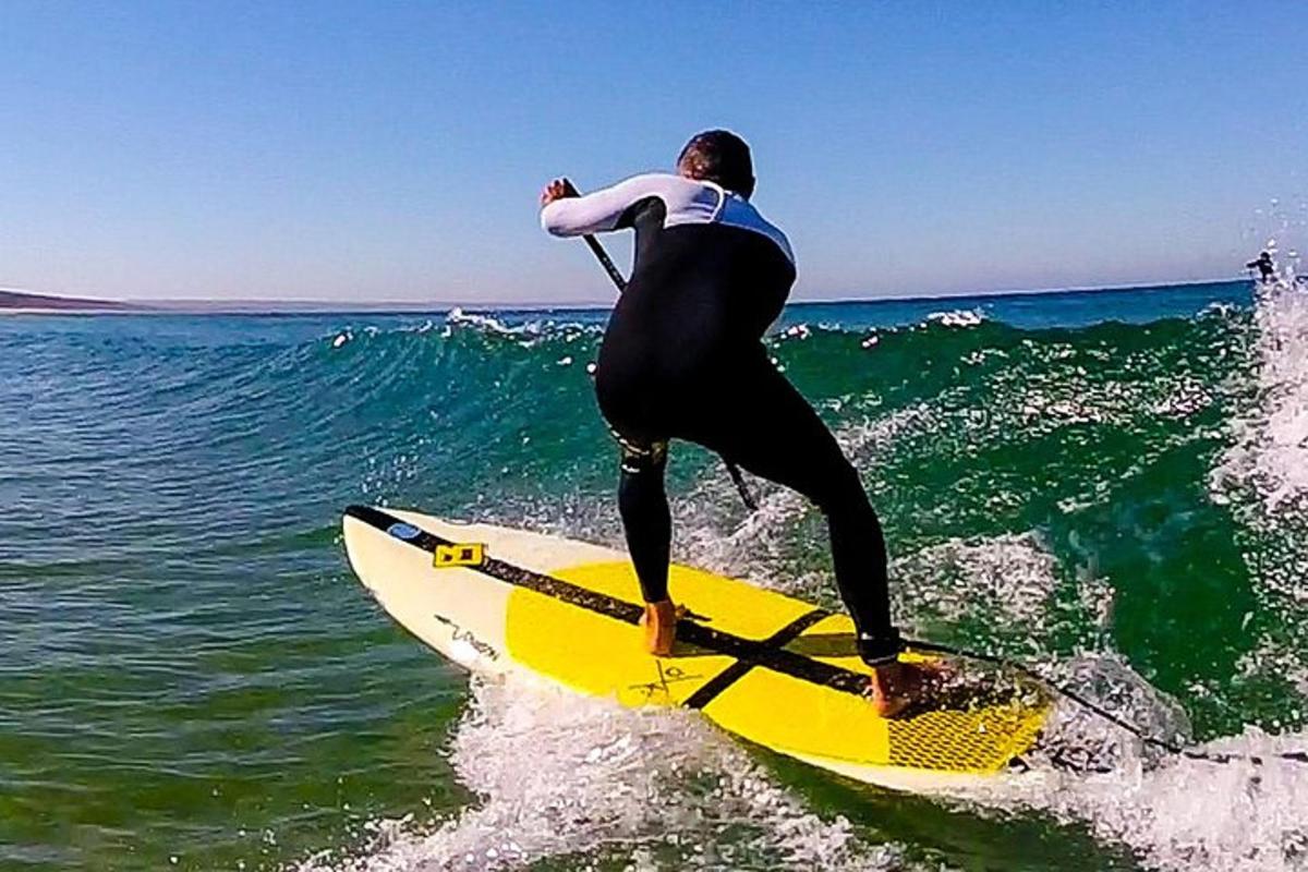 muž jedoucí na vlně na surfovém prkně v oceánu