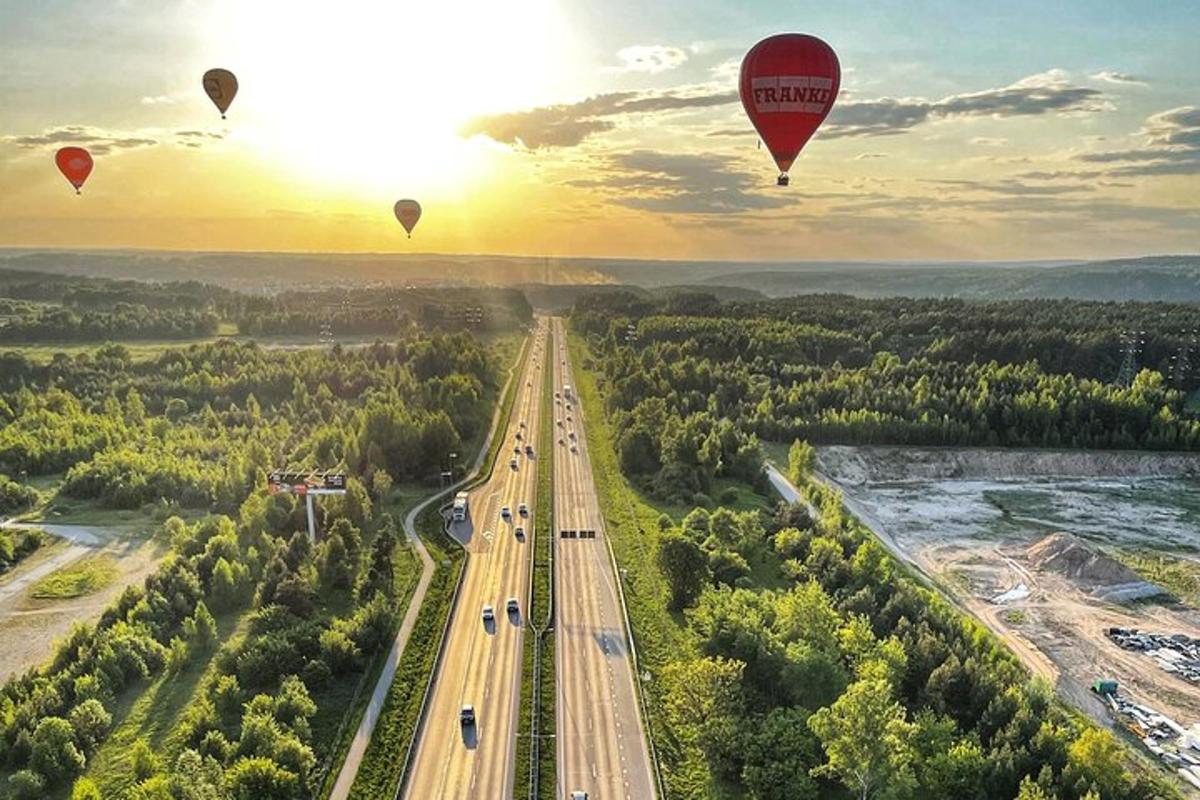 un gruppo di mongolfiere che sorvolano un'autostrada