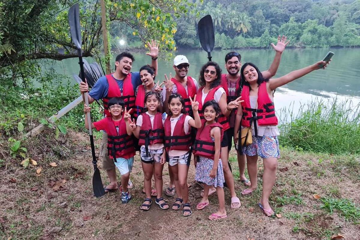 a group of people posing for a picture next to a lake