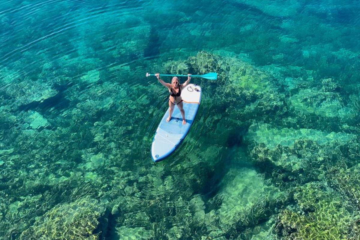 eine Frau, die auf einem Paddleboard im Meer reitet