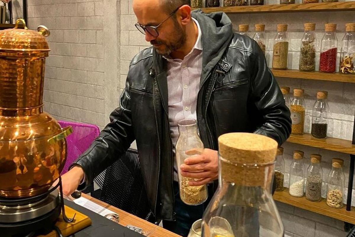 a man in a leather jacket holding a glass bottle