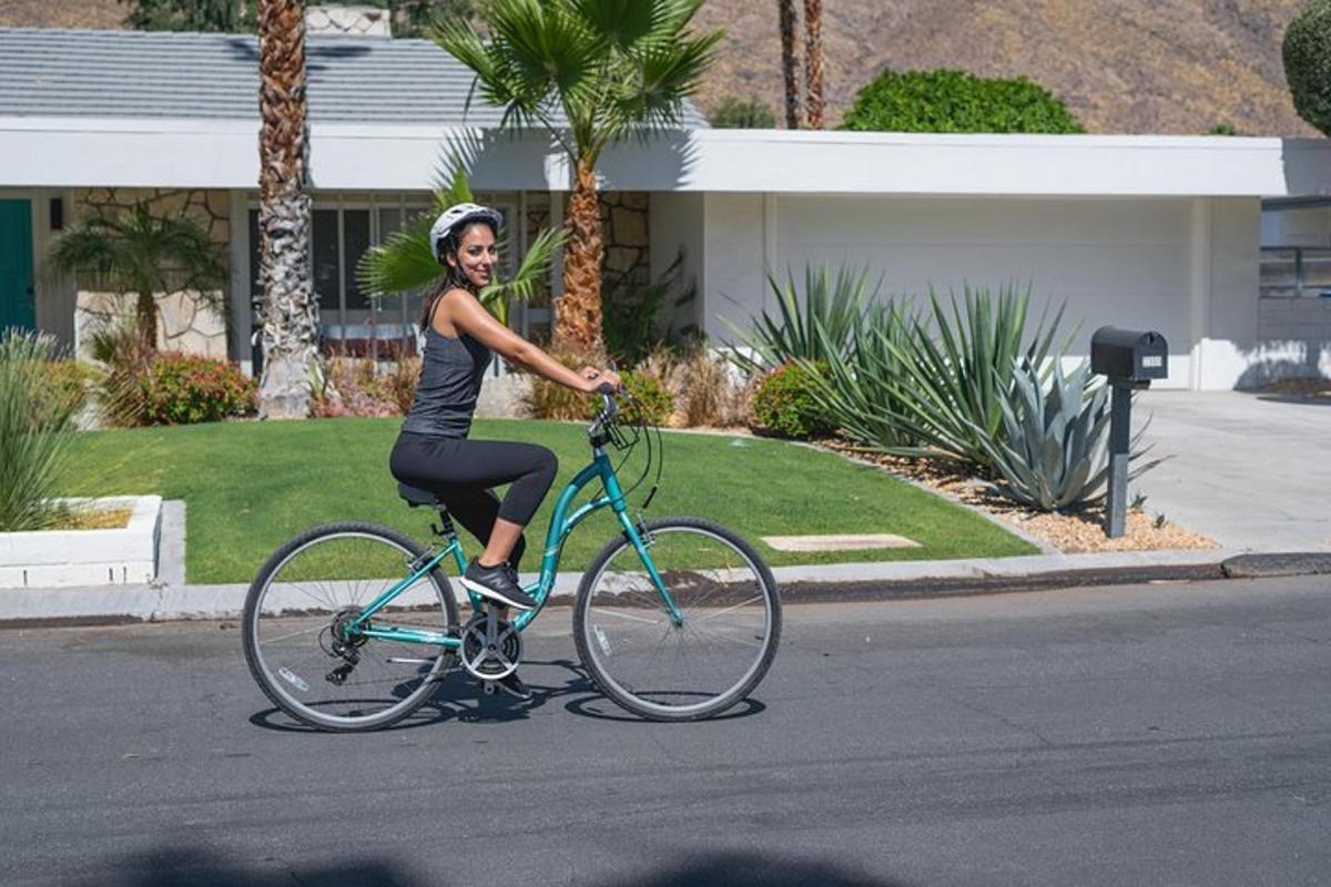 a woman riding a bike down a street