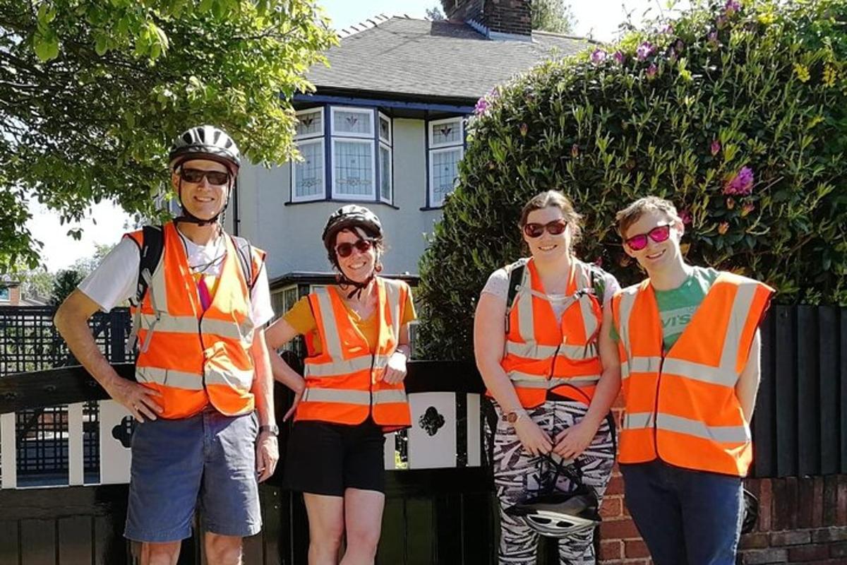 a group of people wearing safety vests in front of a house