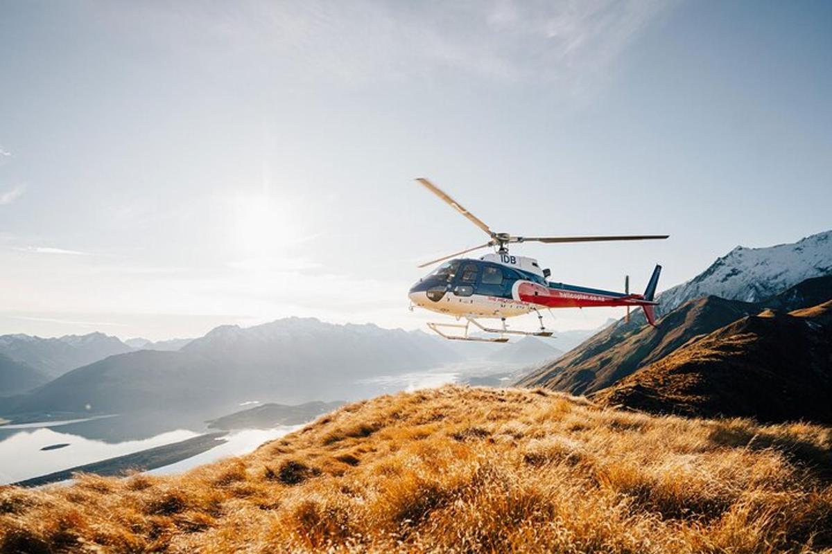 a helicopter is flying over a mountain