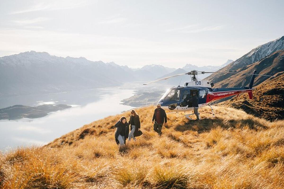 a group of people walking towards a helicopter