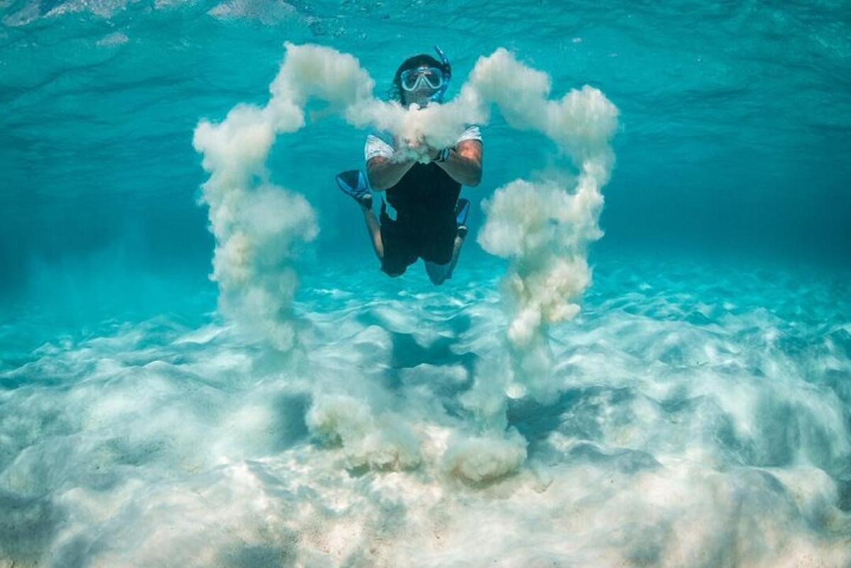 a person is floating in the water with smoke
