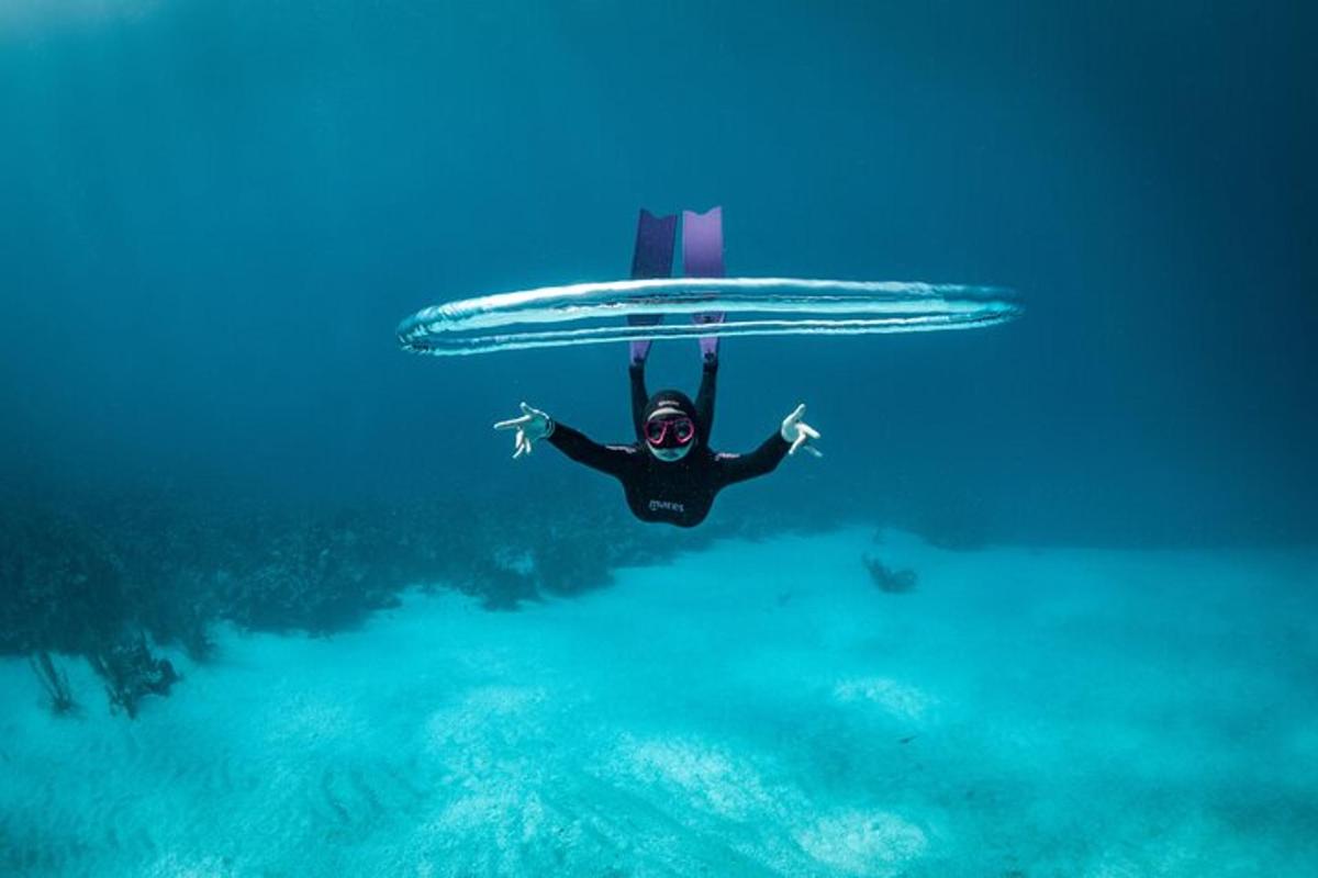 a man flying through the water with a diver