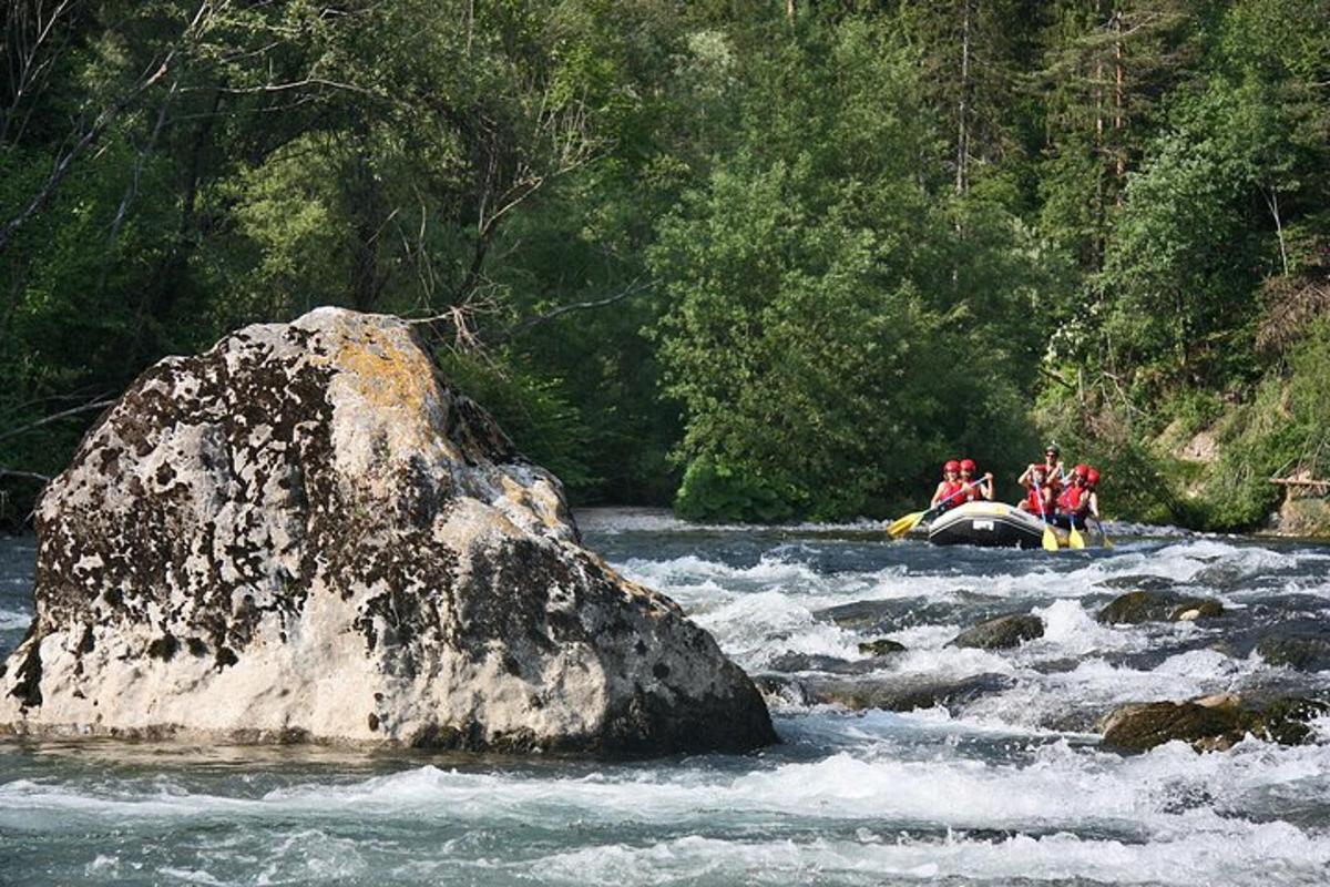 un gruppo di persone che fa rafting su una roccia in un fiume