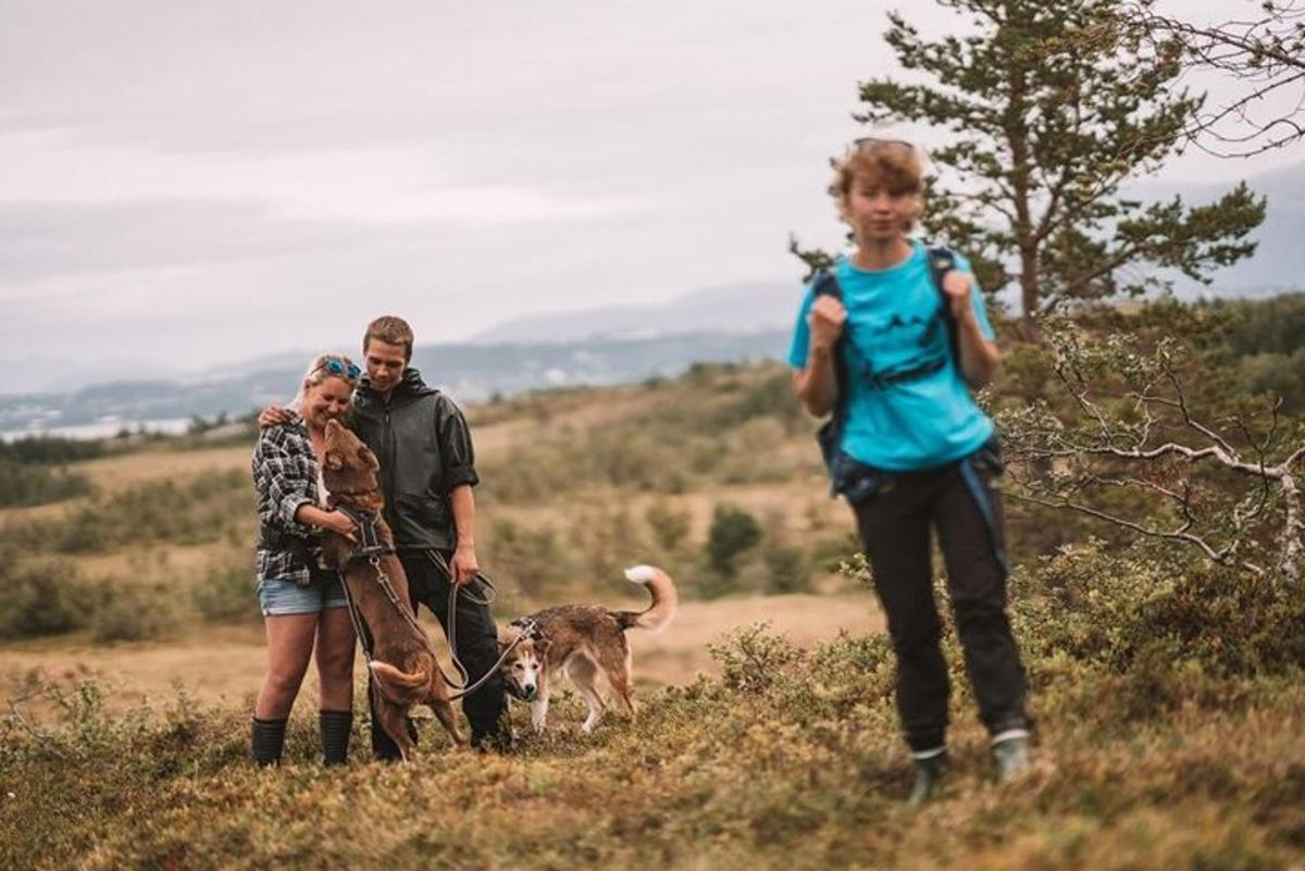 a group of people with a dog in a field