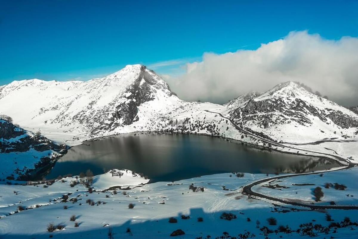 a snow covered mountain with a lake in front of it