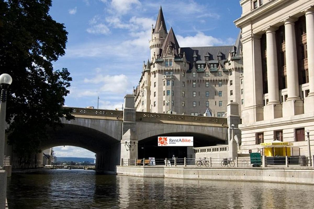 a bridge over a river in front of a large building