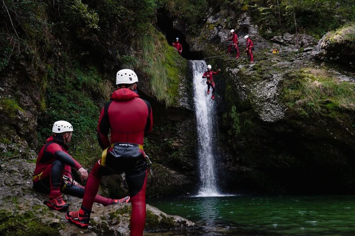 a group of people standing in front of a waterfall