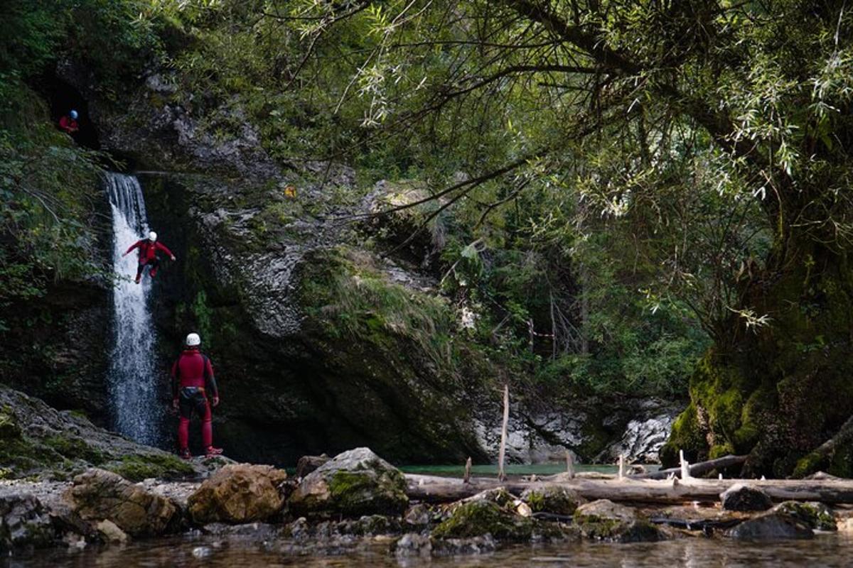 a man is standing in front of a waterfall