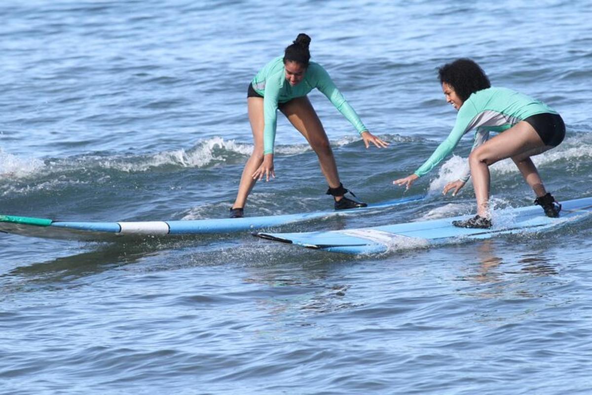dues noies naveguen sobre taules de surf a l'aigua
