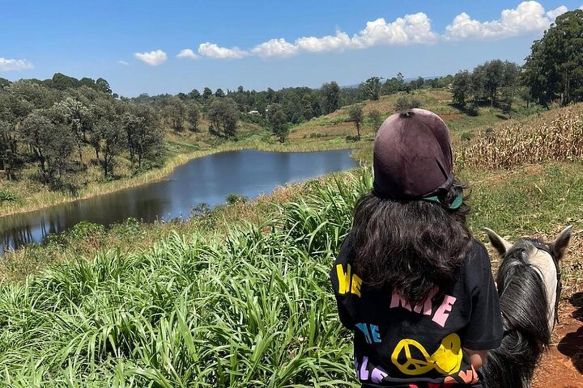 a person sitting on a hill looking at a river