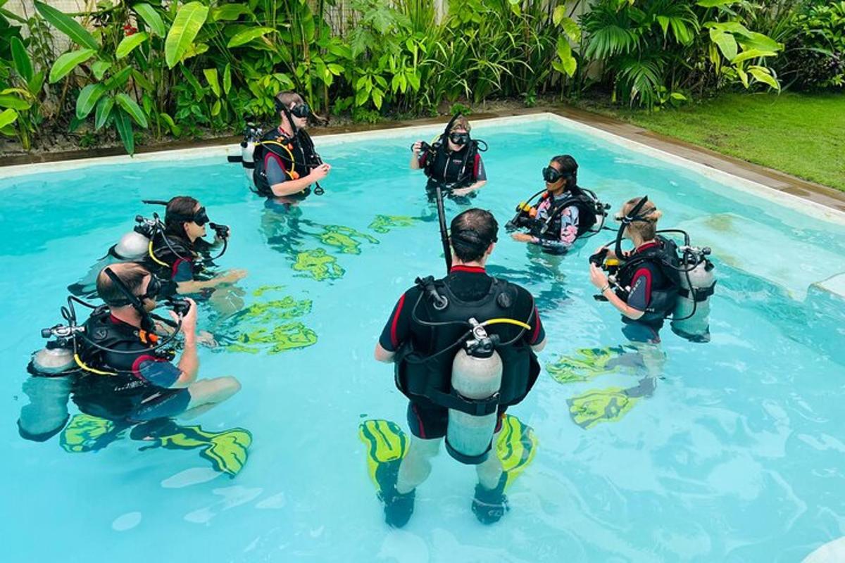 a group of people in the water in a swimming pool