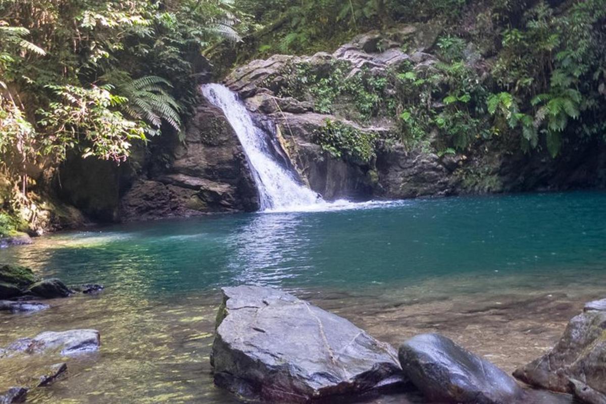 a waterfall in the middle of a pool of water