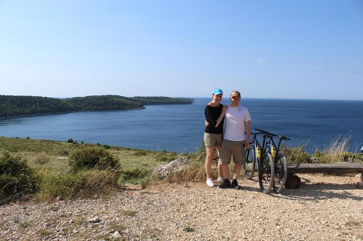 a man and a woman standing next to a bike