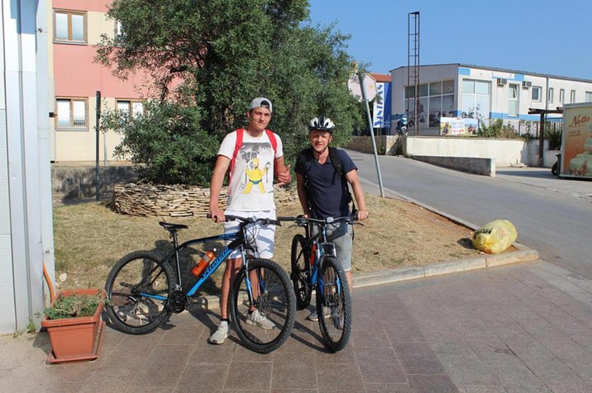 a man and a woman standing next to their bikes