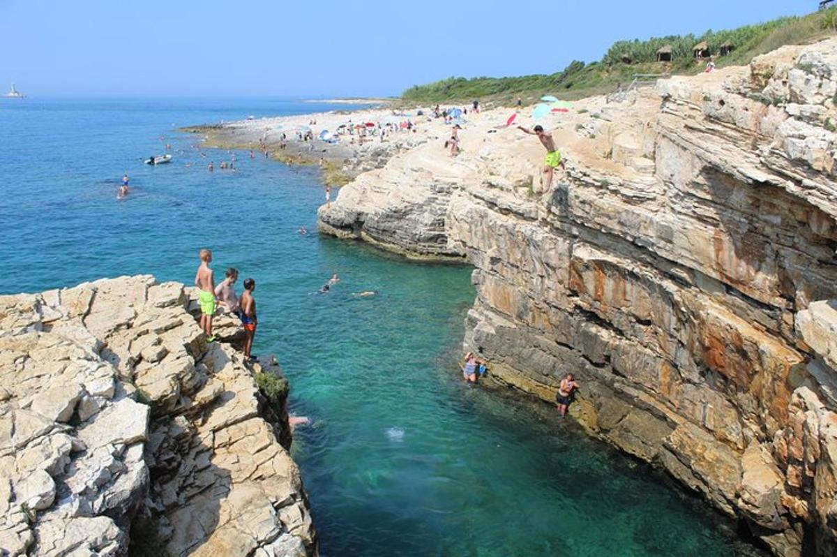 a group of people in the water at a beach
