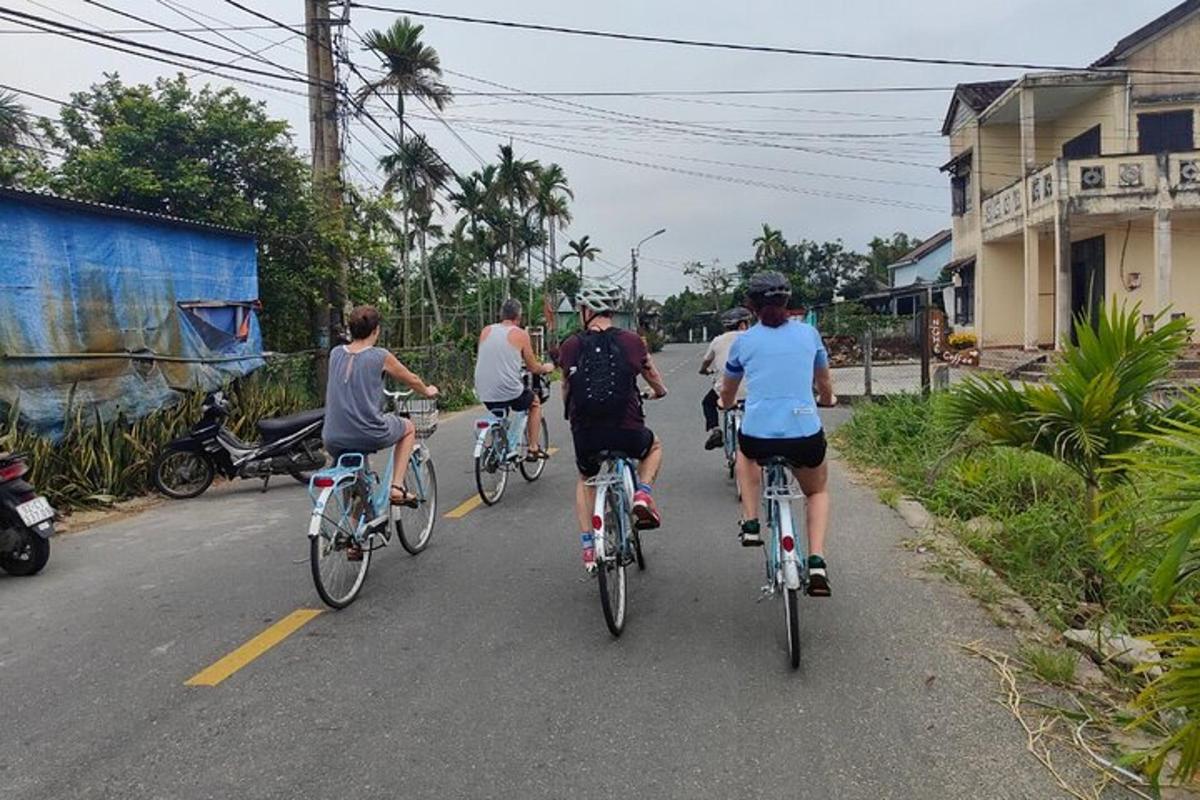 a group of people riding bikes down a street
