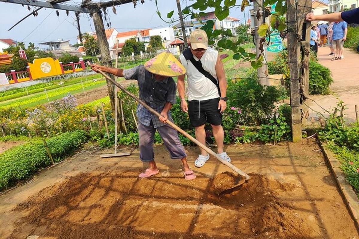 two people are digging in the dirt in a garden