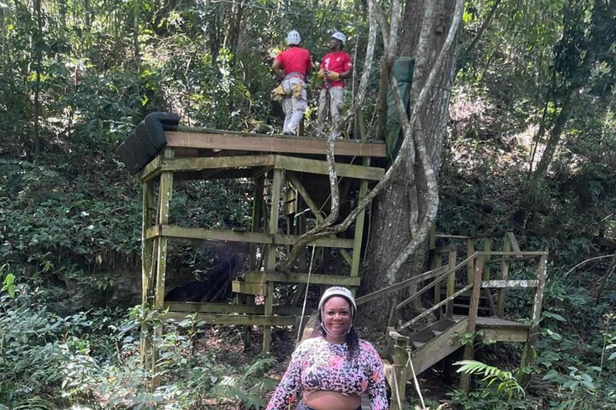 uma mulher sentada em frente a uma casa na árvore