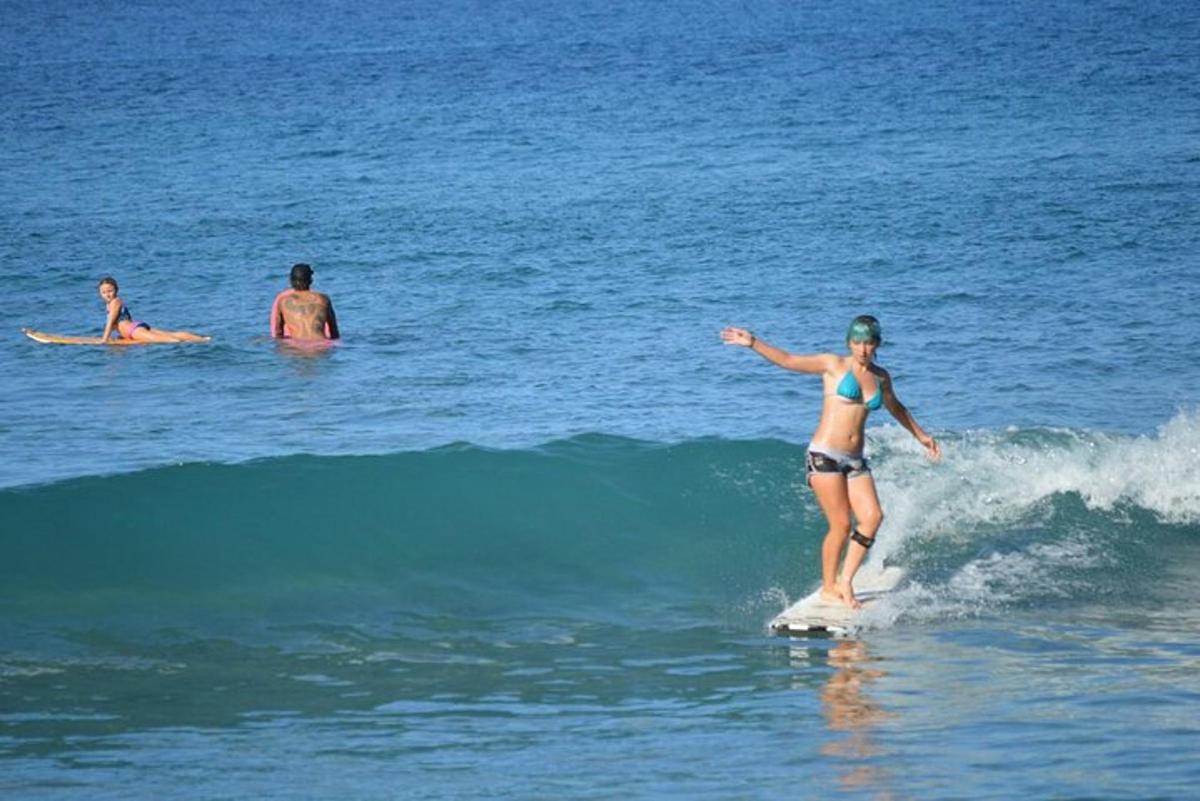 a woman riding a wave on a surfboard in the ocean