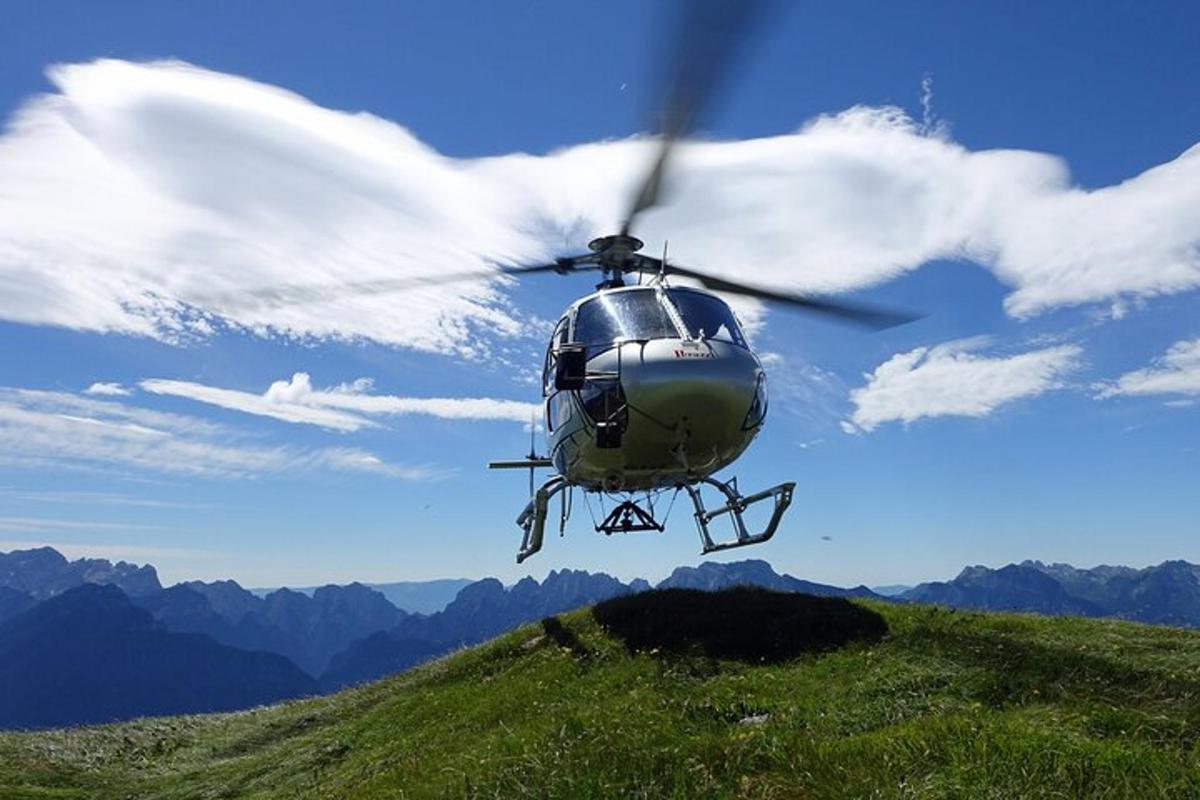 um helicóptero está voando sobre uma colina gramada